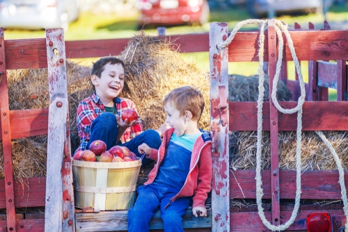Two kids enjoying fall hay ride